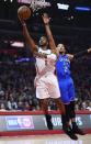 Los Angeles Clippers guard Chris Paul, left, shoots as Oklahoma City Thunder forward Andre Roberson defends during the first half of an NBA basketball game, Monday, Jan. 16, 2017, in Los Angeles. (AP Photo/Mark J. Terrill)