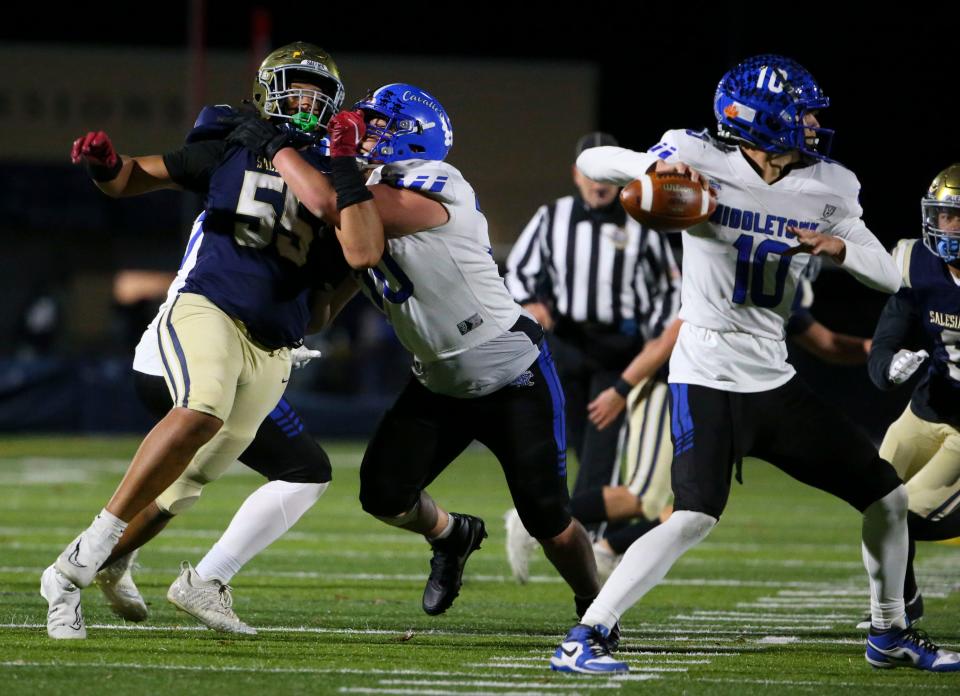 Salesianum's Ahmaad Foster (left) is blocked by Middletown's Eli Curran as he tries to move for quarterback Austin Troyer in the fourth quarter of Salesianum's 24-14 win in a DIAA Class 3A state tournament semifinal at Abessinio Stadium, Friday, Nov. 24, 2023.
