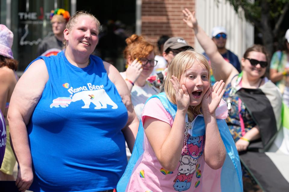 Flower Nichols cheers during the Pride Parade, Saturday, June 10, 2023, in Indianapolis. Families around the U.S. are scrambling to navigate new laws that prohibit their transgender children from accessing gender-affirming care.