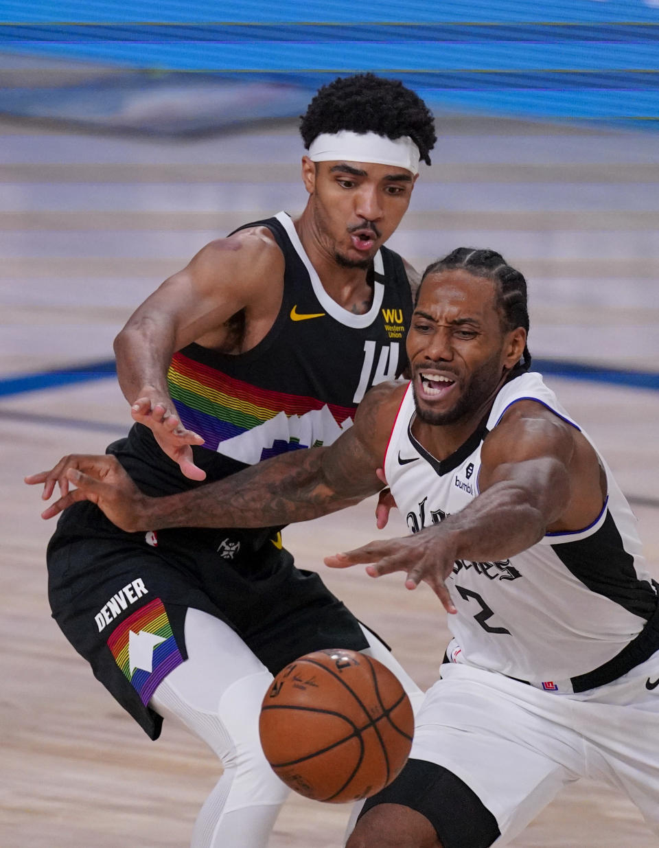 Los Angeles Clippers' Kawhi Leonard (2) reaches for the ball as Denver Nuggets' Gary Harris (14) defends during the second half of an NBA conference semifinal playoff basketball game Monday, Sept. 7, 2020, in Lake Buena Vista, Fla. (AP Photo/Mark J. Terrill)