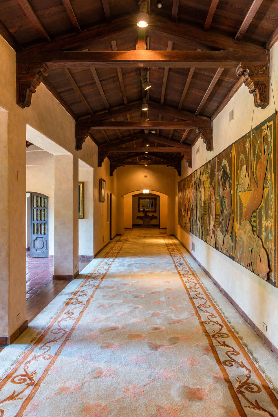 8) The grand upstairs hallway is more than 102 feet long and features a 40-foot wide, nearly 9-foot-tall Dennis Abbe mural that was commissioned by Hugh Hefner.