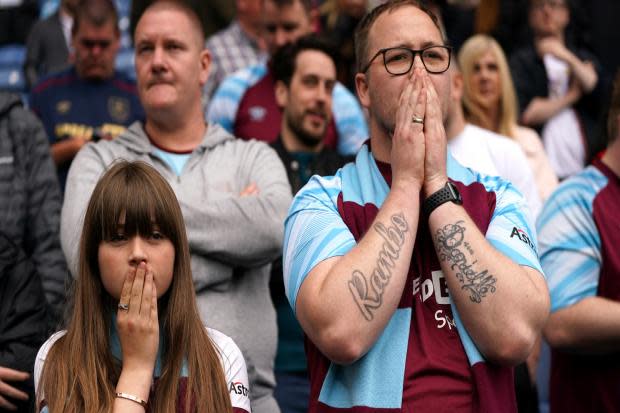 Devastated Burnley fans look on as their side are relegated from the Premier League. Pic: PA