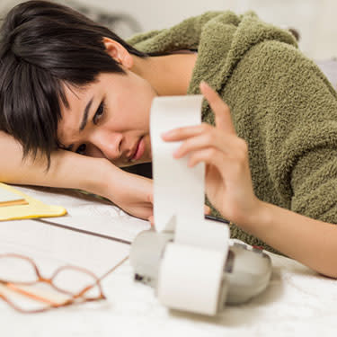 Stressed-woman-looking-at-reciept_web