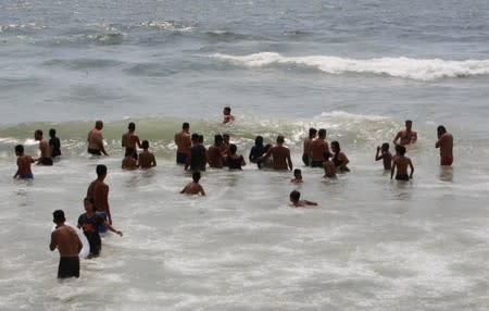 People swim at Ramlet al-Bayda public beach in Beirut