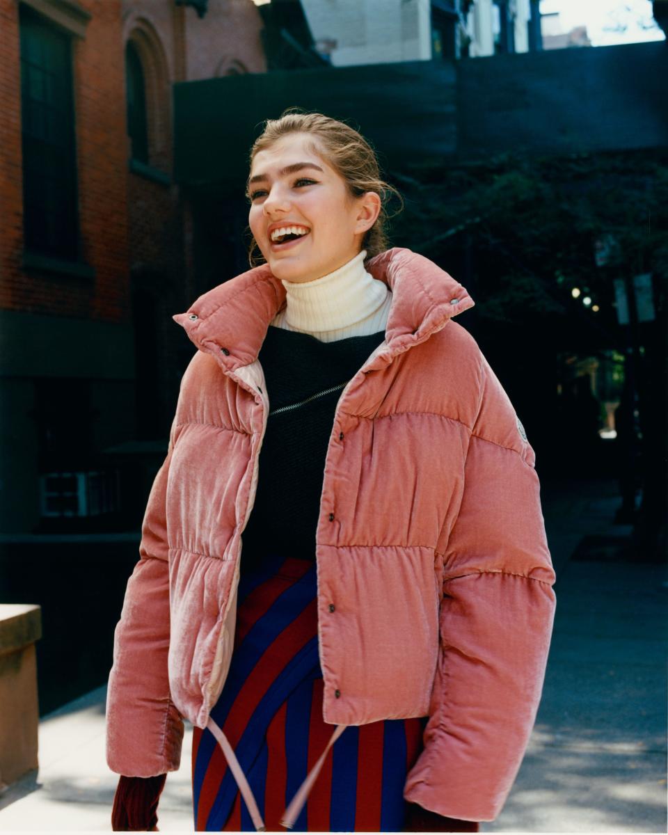 Skylar Tartz plays with proportions in her cropped <a rel="nofollow noopener" href="https://weallwear.moncler.com/" target="_blank" data-ylk="slk:Moncler Cercis jacket;elm:context_link;itc:0;sec:content-canvas" class="link ">Moncler Cercis jacket</a>, $1,295, <a rel="nofollow noopener" href="https://weallwear.moncler.com/" target="_blank" data-ylk="slk:Moncler wool gloves;elm:context_link;itc:0;sec:content-canvas" class="link ">Moncler wool gloves</a>, $300, and a high-waisted skirt.