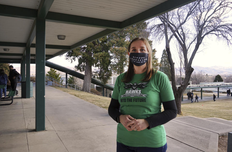 Counselor Carly Lott stands outside her office at Procter R. Hug High School in Reno, Nev., Friday, Jan. 21, 2022. Lott became concerned about the hours students were working outside the classroom early in the pandemic and its potential effect on graduation rates, which are dipping in many states for the first time in decades. (AP Photo/Samuel Metz)