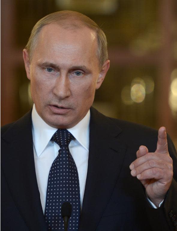 Russia's President Vladimir Putin speaks with journalists in Itamaraty Palace in Brazilia, early on July 17, 2014