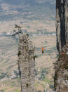 A daredevil high-wire walker is seen traversing a 40m long 'slackline' suspended 1800 meters above sea level without the aid of a safety harness in Shien, China. American Dean Potter crossed from one side of central China's Enshi Grand Canyon to the other in just two minutes - easing his way across while listening to music on his headphones.