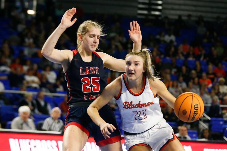 Cookeville's Cassie Gallagher (25) guards Blackman's Emily Monson (21) as she drives to the basket during the TSSAA BlueCross Girls’ Basketball Championship Class 4A quarterfinal game between Blackman and Cookeville in Murfreesboro, Tenn., on Wednesday, March 8, 2023. 