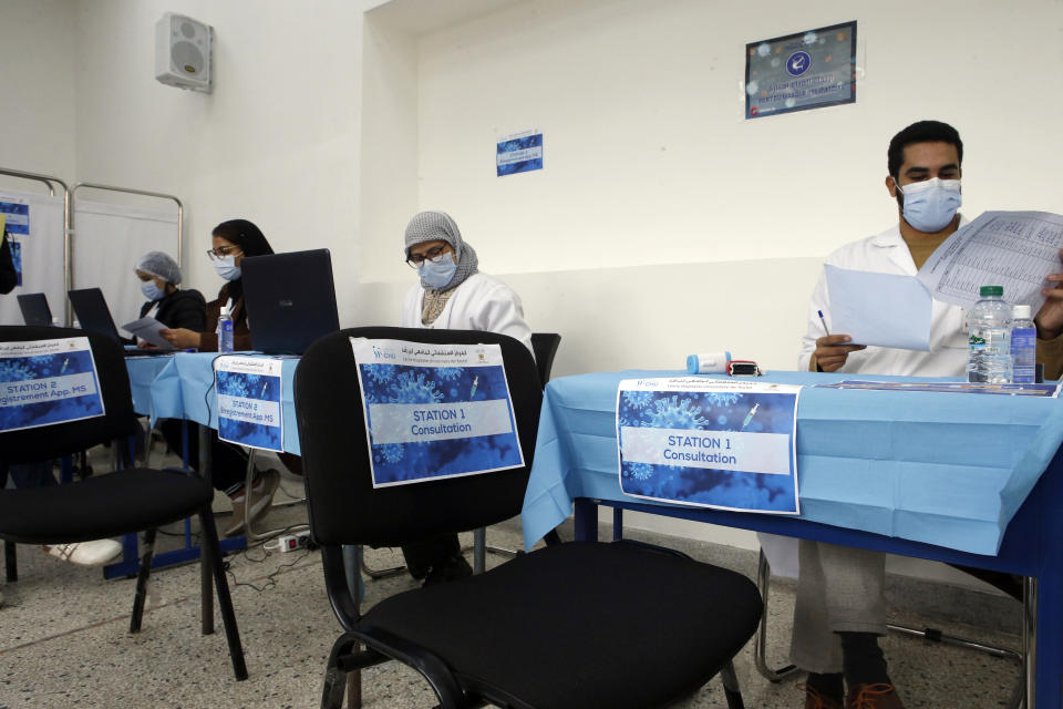 Moroccan doctors wait for members of the health agency for a consultation, on the first day of the vaccination campaign, in Casablanca, Morocco, Friday, Jan. 29, 2021. The King of Morocco Mohammed VI received his vaccine against coronavirus Thursday at the palace Royal Fez launching and officially the vaccination campaign Covid-19 in his country, it will aim at first mainly health workers, security forces and people over 75 years, according to the Moroccan authorities. (AP Photo/Abdeljalil Bounhar)