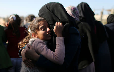 The sister of Palestinian boy Ahmed Abed is comforted as she mourns during his funeral in Khan Younis in the southern Gaza Strip December 12, 2018. REUTERS/Ibraheem Abu Mustafa