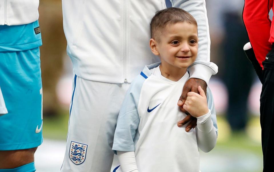 Bradley Lowery holds hands with England's Jermain Defoe prior to the World Cup qualifying game between England and Lithuania at Wembley - AP