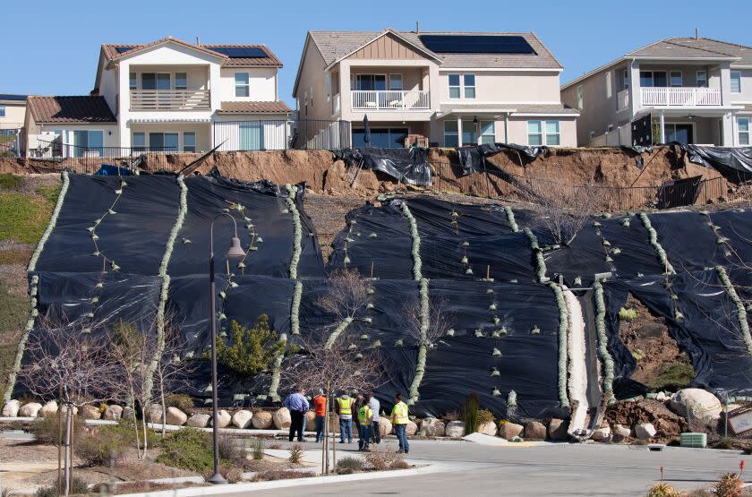 SANTA CLARITA, CA - FEBRUARY 06: A hillside behind homes on Plume Way in the Santa Clarita neighborhood of Canyon Country slid down to Lambent Way damaging the sidewalk. Photographed on Monday, Feb. 6, 2023 in Santa Clarita, CA. (Myung J. Chun / Los Angeles Times)