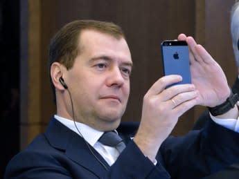 Russian Prime minister Dmitry Medvedev takes a picture of the Eiffel Tower with his smartphone during a meeting, on November 27, 2012, at French employers association MEDEF's headquarters in Paris. AFP PHOTO ERIC FEFERBERG        (Photo credit should read ERIC FEFERBERG/AFP/Getty Images)