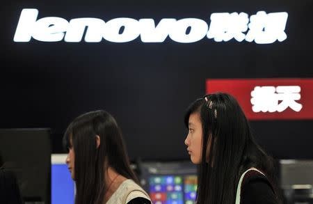 People walk past a Lenovo shop in Hefei, Anhui province, October 18, 2013. REUTERS/Stringer