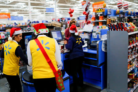 FILE PHOTO: Walmart workers organise products for Christmas season at a Walmart store in Teterboro, New Jersey, U.S., October 26, 2016. REUTERS/Eduardo Munoz/File Photo