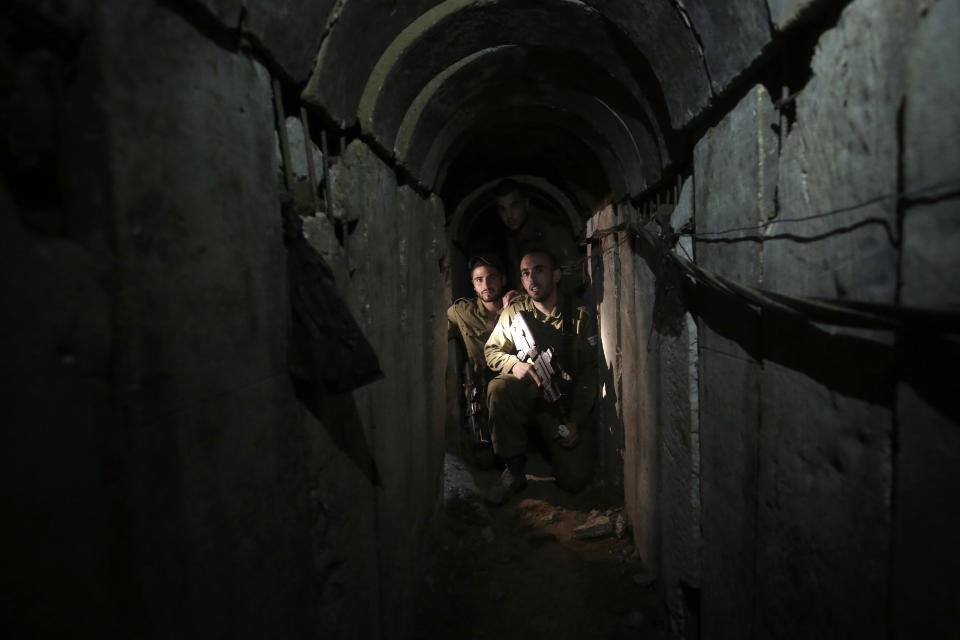 Israeli soldiers walk through a tunnel discovered near the Israel-Gaza border, Oct. 13, 2013. (AP/Tsafrir Abayov, File)