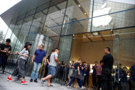 People enter an Apple store to purchase the new iPhone 7, in Beijing, China September 16, 2016. REUTERS/Thomas Peter