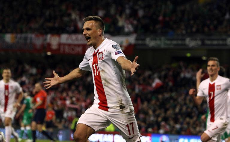 Poland's midfielder Slawomir Peszko celebrates scoring the opening goal of the Euro 2016 qualifying football match between Ireland and Poland in Dublin on March 29, 2015