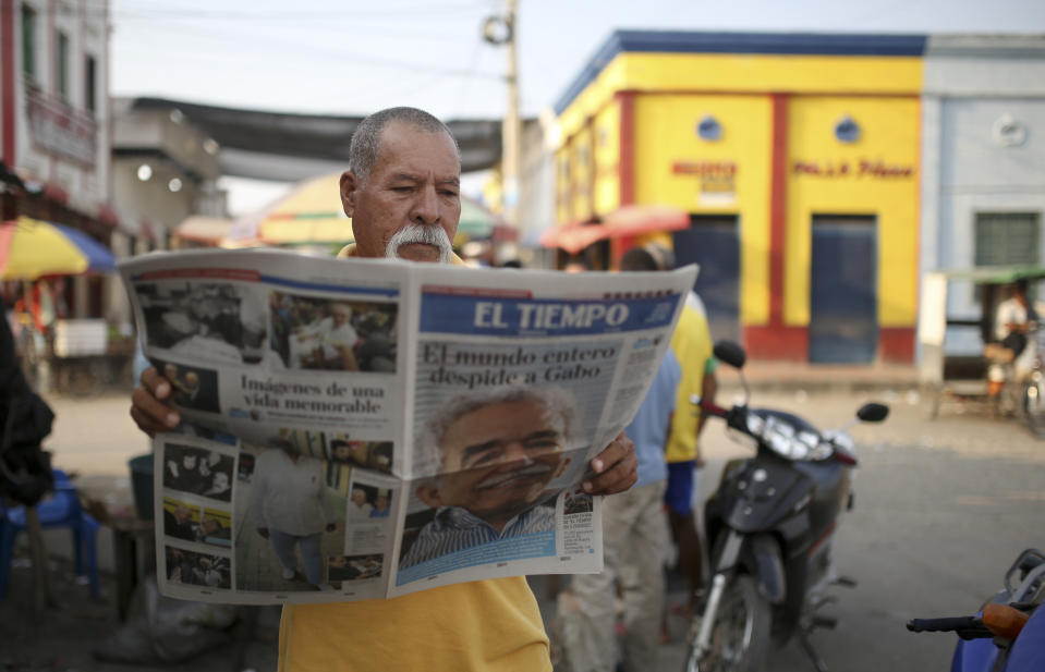 A man reads a newspaper fronted with the news of the death of Nobel laureate Gabriel Garcia Marquez, in Aracataca, the town were he was born in Colombia's Caribbean coast, Friday, April 18, 2014. Garcia Marquez died in Mexico City on Thursday. (AP Photo/Ricardo Mazalan)