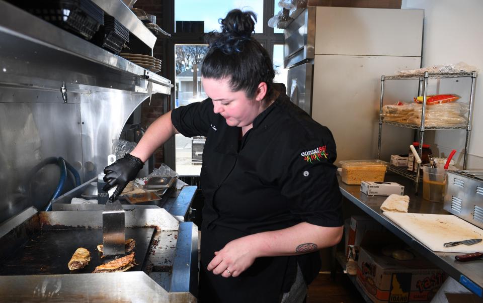 Dayna Lee-Márquez of the Comal 864 restaurant in Greenville prepares food for guests.