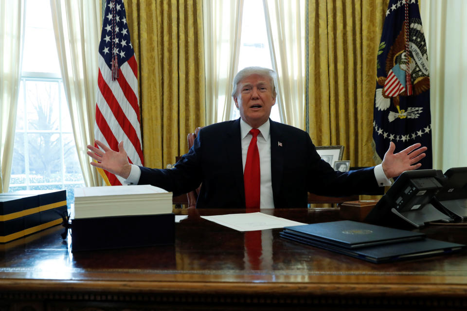 U.S. President Donald Trump delivers remarks before signing sweeping tax overhaul legislation into law in the Oval Office at the White House in Washington, U.S. December 22, 2017.  REUTERS/Jonathan Ernst