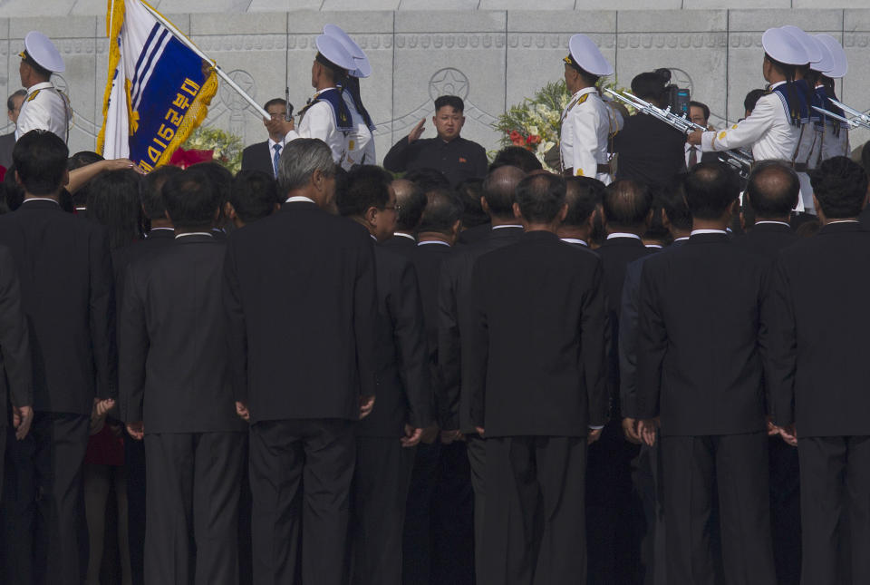 North Korean leader Kim Jong Un, center, salutes during an opening ceremony for a cemetery for Korean War veterans on Thursday, July 25, 2013 in Pyongyang, North Korea marking the 60th anniversary of the signing of the armistice that ended hostilities on the Korean peninsula. (AP Photo/David Guttenfelder)