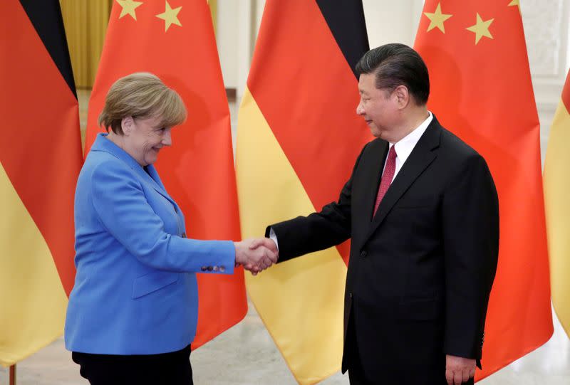 FILE PHOTO: China's President Xi Jinping meets German Chancellor Angela Merkel at the Great Hall of the People in Beijing
