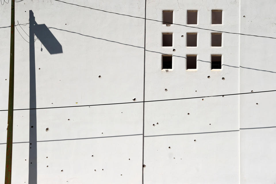 A wall is pockmarked with bullet holes in Culiacan on Oct. 18. | Alfredo Estrella—AFP/Getty Images