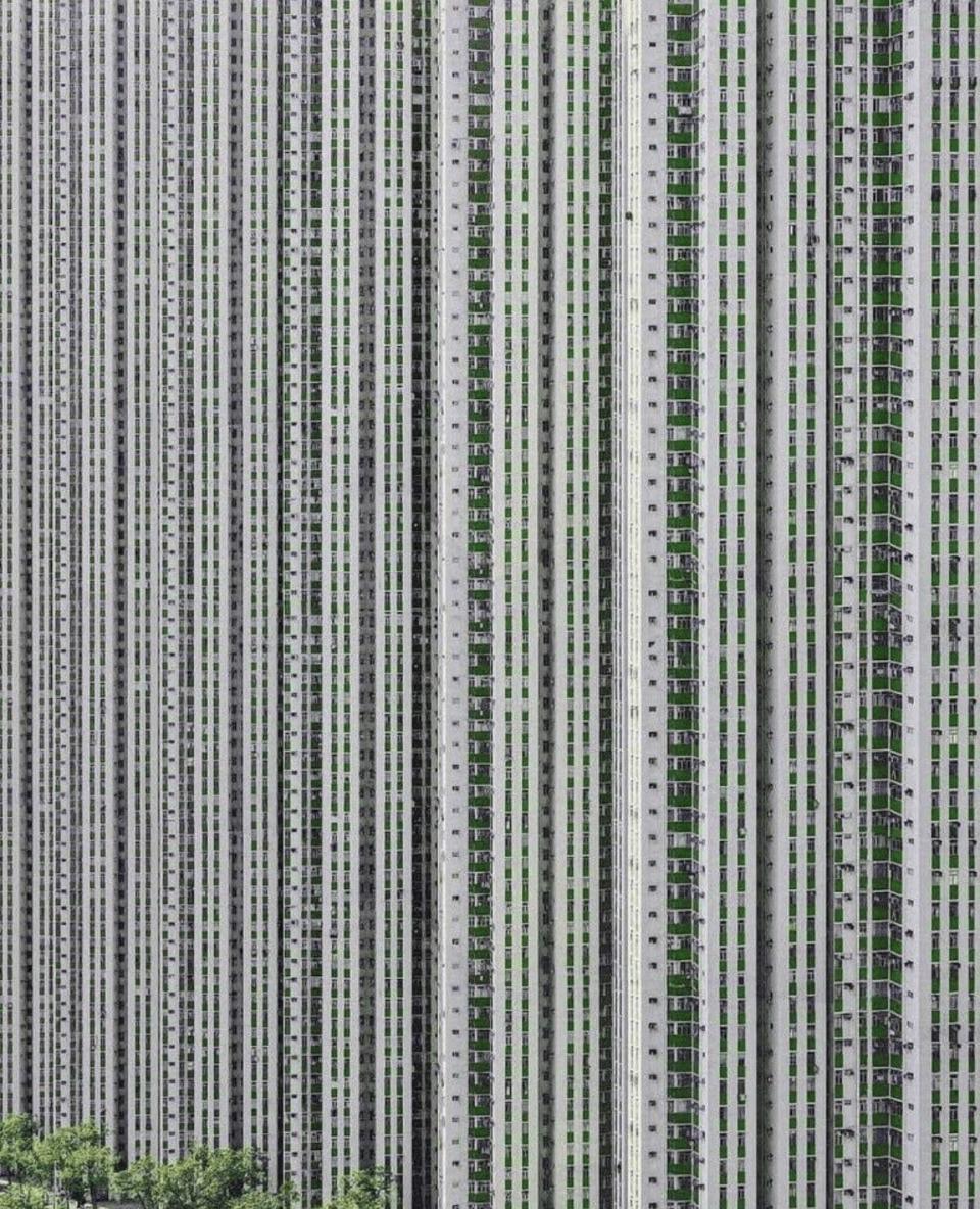 High-rise apartment buildings with repetitive, vertical patterns of windows and balconies