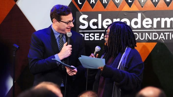 This Dec. 2014 photo captures comics Bob Saget (left) and Whoopi Goldberg (right) at “Cool Comedy-Hot Cuisine,” a benefit for The Scleroderma Research Foundation, at Caroline’s On Broadway in New York City. (Photo: Ilya S. Savenok/Getty Images)