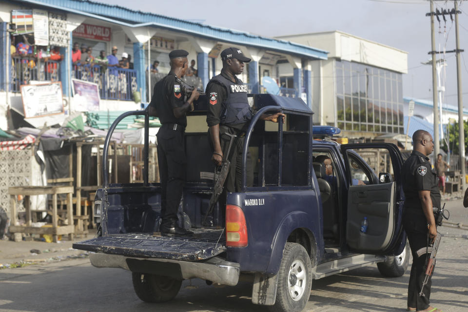 Police officers patrol near the Lekki toll gate in Lagos, Nigeria, Wednesday Oct. 21, 2020. After 13 days of protests against alleged police brutality, authorities have imposed a 24-hour curfew in Lagos, Nigeria's largest city, as moves are made to stop growing violence. ( AP Photo/Sunday Alamba)