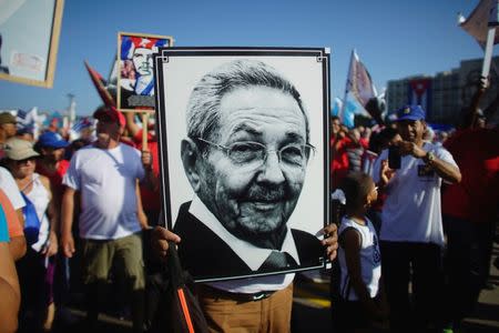 A person carries a picture of Cuban President Raul Castro during a May Day rally in Havana, Cuba, May 1, 2017. REUTERS/Alexandre Meneghini/Files