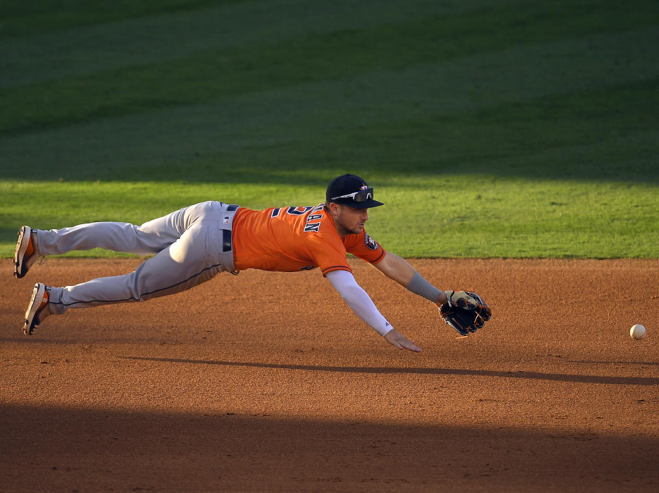 Houston Astros third baseman Alex Bregman cannot get to a ball hit for a single by Los Angeles Angels' Anthony Rendon during the eighth inning of a baseball game Saturday, Aug. 1, 2020, in Anaheim, Calif. (AP Photo/Mark J. Terrill)