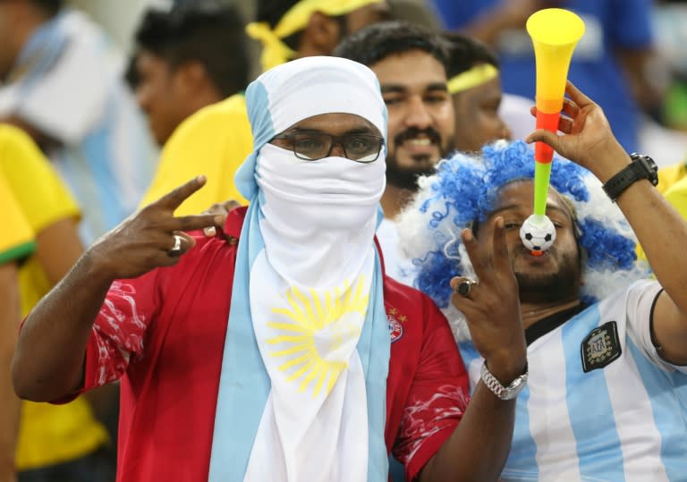 Local fans from Saudi Arabia ham it up during the Brazil Argentina game