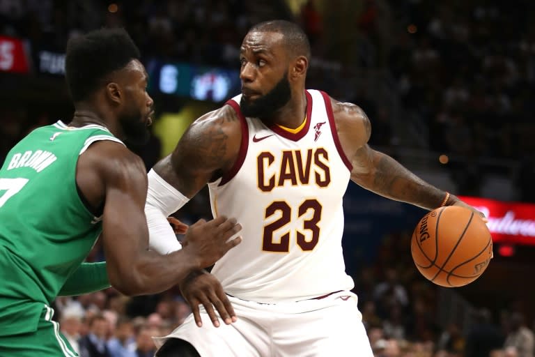 LeBron James of the Cleveland Cavaliers looks to get past Jaylen Brown of the Boston Celtics during the first half, at Quicken Loans Arena in Cleveland, Ohio, on October 17, 2017