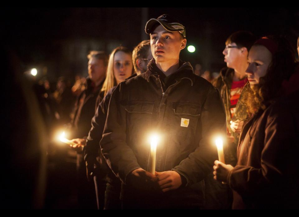 Students and those in the community embrace one another as they hold a candlelight vigil at St Mary's of the Assumption Church in Chardon, Ohio on Feb. 28, 2012.