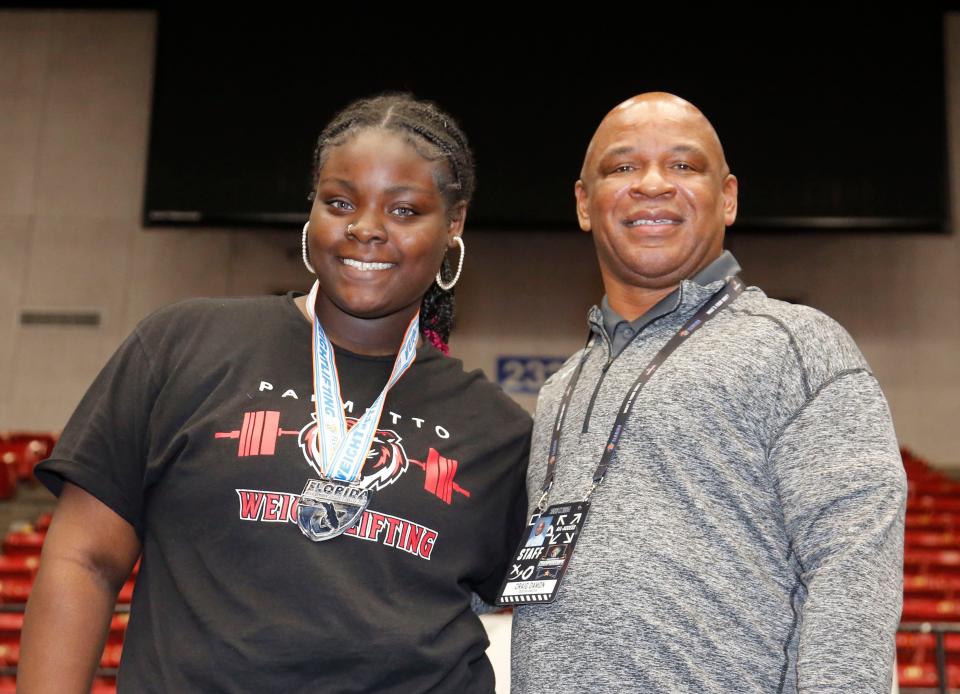 Sherrickia King of Palmetto stands with executive Director Craig Damon of the Fshaa after presenting her with the 2nd place medal in Traditional weightlifting. FHSAA Girls Weightlifting state Championship at the RP Funding Center in Lakeland Fl. February 16th 2024, 2023 Photo by Calvin Knight