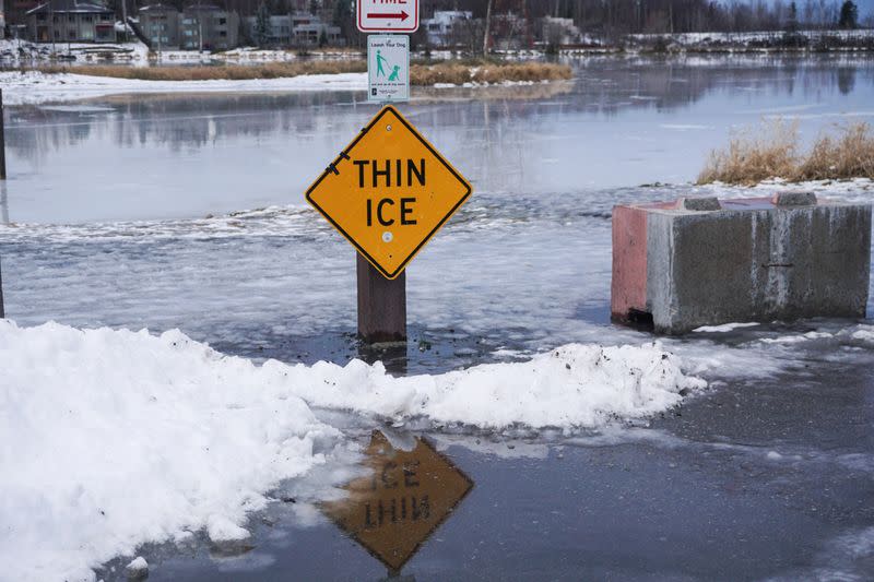 FILE PHOTO: Winter rains atop of snow create a glaze on roads and parking lots and melt Westchester Lagoon, a popular ice-skating and pond-hockey site in Anchorage