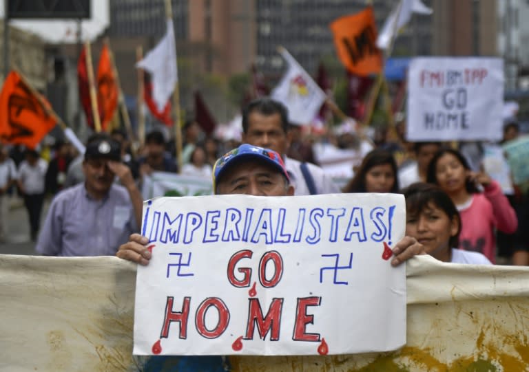 Demonstrators protest against the International Monetary Fund/World Bank annual meetings taking place in Lima, Peru on October 9, 2015