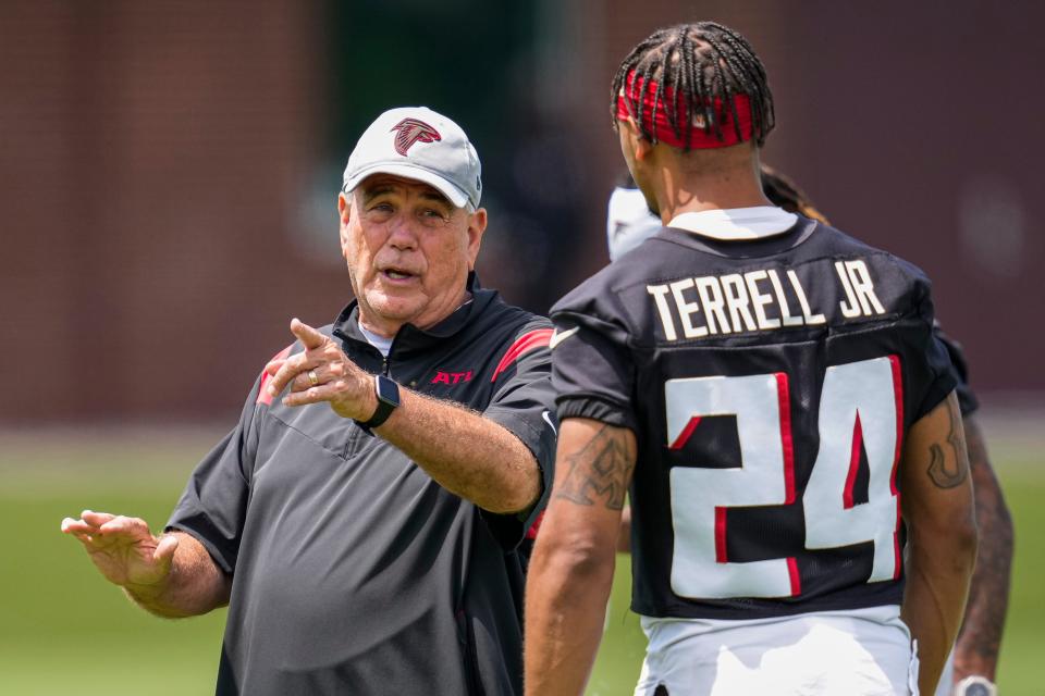 Atlanta Falcons defensive coordinator Dean Pees talks to star cornerback A J Terrell.