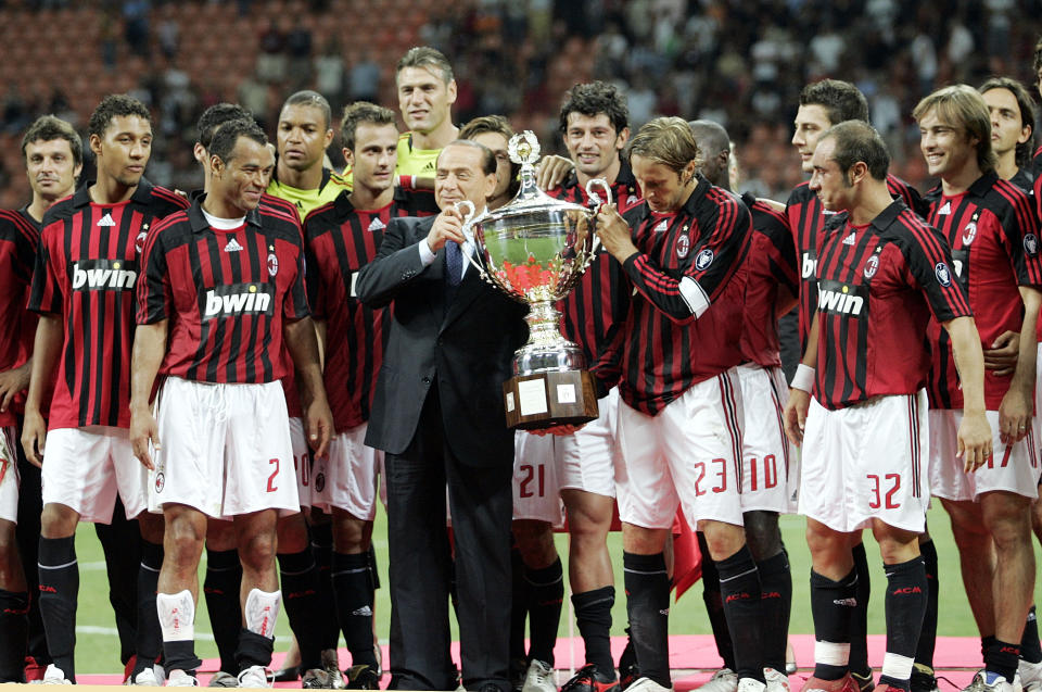 FILE - AC Milan president Silvio Berlusconi, center in dark suit, celebrates with the team after defeating Juventus to win the Luigi Berlusconi Trophy exhibition soccer match at the San Siro stadium in Milan, Italy, on Aug. 17, 2007. Berlusconi, the boastful billionaire media mogul who was Italy's longest-serving premier despite scandals over his sex-fueled parties and allegations of corruption, died, according to Italian media. He was 86. (AP Photo/Alberto Pellaschiar, File)