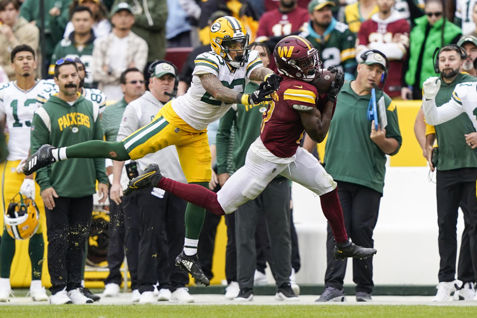 Green Bay Packers cornerback Jaire Alexander (23) tackles Washington Commanders running back Brian Robinson Jr., (8) during the second half of an NFL football game Sunday, Oct. 23, 2022, in Landover, Md. The Commanders won 23-21.(AP Photo/Susan Walsh)