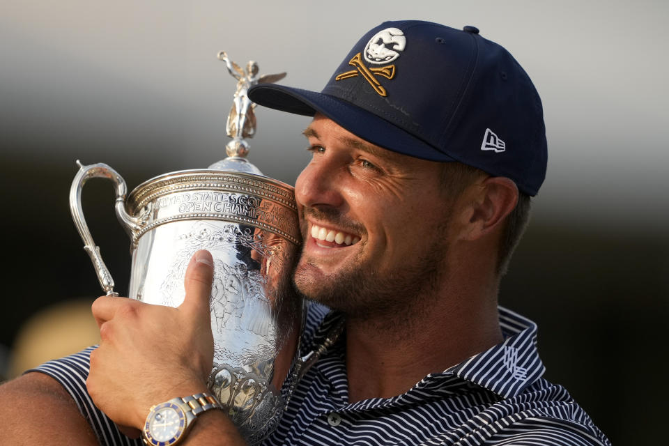 Bryson DeChambeau holds the trophy after winning the U.S. Open golf tournament Sunday, June 16, 2024, in Pinehurst, N.C. (AP Photo/Matt York)