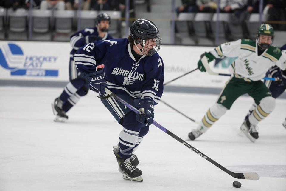 Burrillville's Evan Polacek pushes the puck up the ice against Hendricken on Sunday,