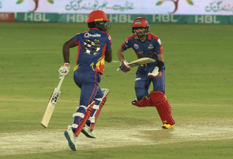 Karachi Kings Babar Azam, right, and Chadwick Walton run between the wickets during the final of their Pakistan Super League T20 cricket match against Lahore Qalandars at National Stadium in Karachi, Pakistan, Tuesday, Nov. 17, 2020. (AP Photo/Fareed Khan)