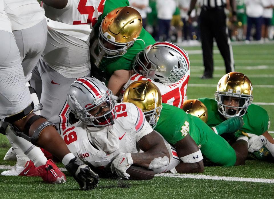 Sep 23, 2023; South Bend, Indiana, USA; Ohio State Buckeyes running back Chip Trayanum (19) scores the game winning rushing touchdown against Notre Dame Fighting Irish during the fourth quarter of their game at Notre Dame Stadium.