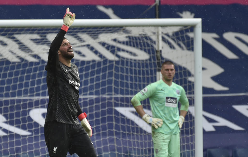 Liverpool's goalkeeper Alisson celebrates after scoring his side's second goal during the English Premier League soccer match between West Bromwich Albion and Liverpool at the Hawthorns stadium in West Bromwich, England, Sunday, May 16, 2021. (AP Photo/Rui Vieira, Pool)