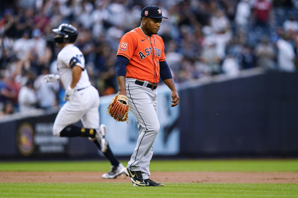 Houston Astros starting pitcher Framber Valdez walks in the infield as New York Yankees' Giancarlo Stanton runs the bases after hitting a three-run home run during the first inning of a baseball game Thursday, June 23, 2022, in New York. (AP Photo/Frank Franklin II)