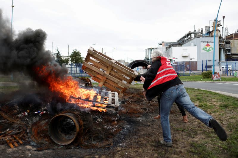 FILE PHOTO: Workers on strike burn a fire in front of the ExxonMobil oil refinery in Port-Jerome-sur-Seine